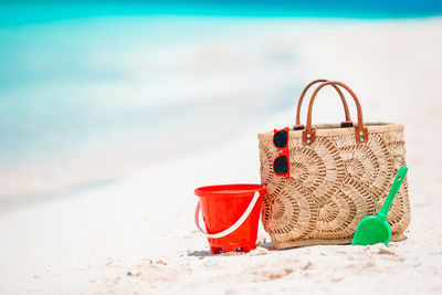 Red wicker basket on sand at beach