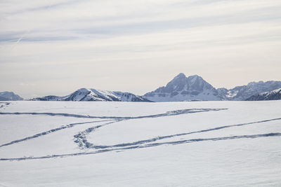 Scenic view of snow covered mountains against sky