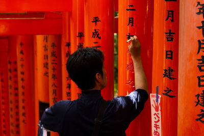 Full length of friends outside temple in building