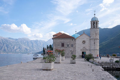 View of historic building by mountains against sky