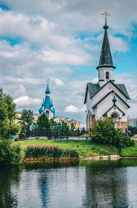 Church by building against sky