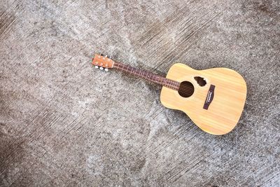 High angle view of playing guitar on wood