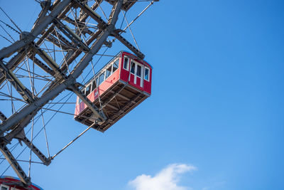 Low angle view of crane against blue sky