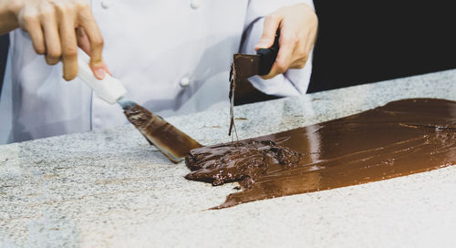 Midsection of man working on table