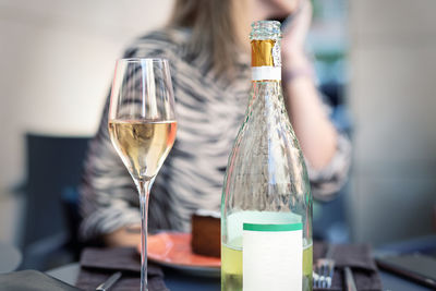 Close-up of wine glass bottle on table