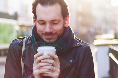 Close-up of man holding disposable cup