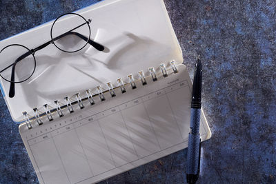 High angle view of spiral notebook on table