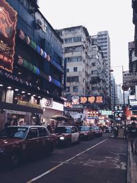 Cars on road in city against clear sky