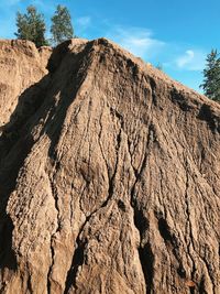 Low angle view of rock formation on land against sky