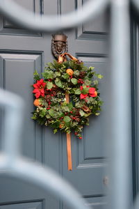 Wreath on door seen through window