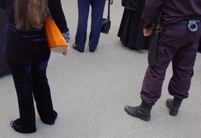 Low section of people standing on street