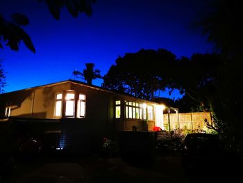 Illuminated building against sky at night