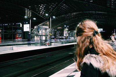 Woman at railroad station in city