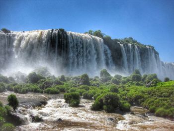 Scenic view of waterfall against clear sky