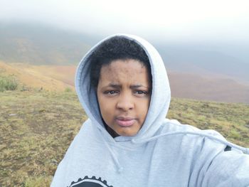 Portrait of woman standing on mountain