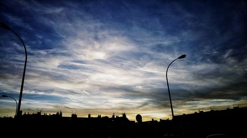 Silhouette city against sky during sunset