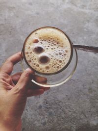 Close-up of hand holding coffee cup