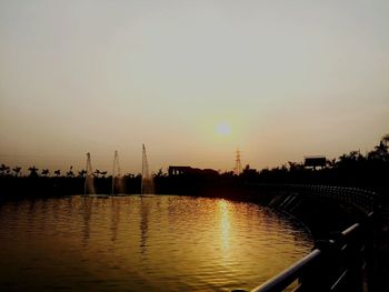 Scenic view of river against sky at sunset