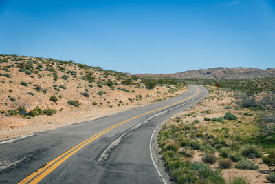 Road winding through desert landscape