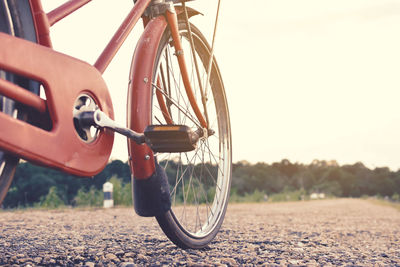 Close-up of bicycle on road against sky