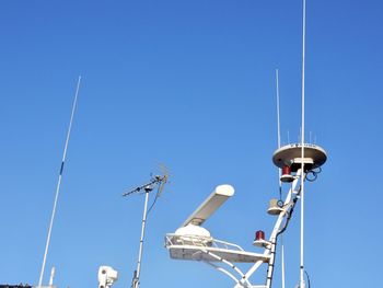 Low angle view of radar against clear blue sky