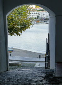 Bridge over river by buildings in city