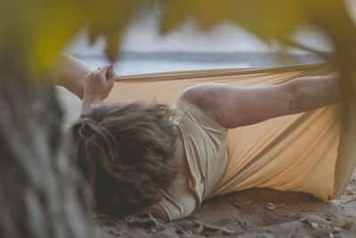 Midsection of man holding leaf at home