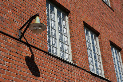 Low angle view of brick wall by building
