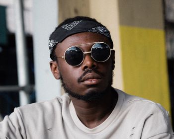 Close-up portrait of young man wearing sunglasses