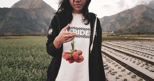 Young woman standing on field