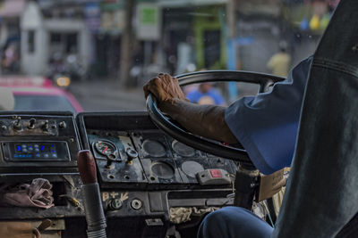 Cropped hand of driver driving truck
