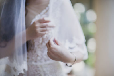 Midsection of woman wearing mask against blurred background