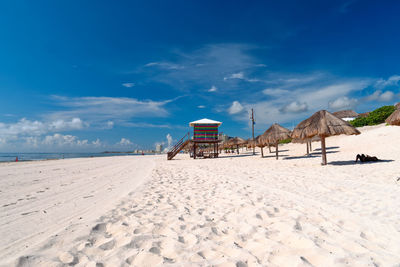 Scenic view of beach against cloudy sky