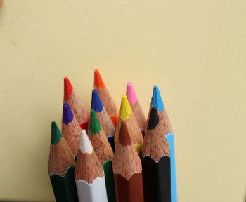 Close-up of multi colored pencils against white background