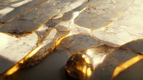 Background of cracked marble with shining golden mineral in it