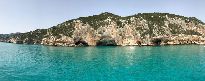 Rock formations in sea against sky