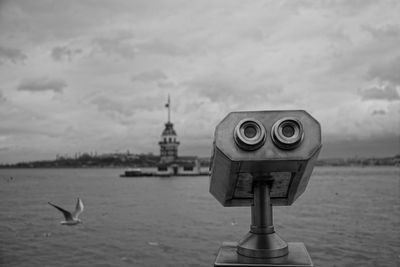 View of seagull on sea against cloudy sky