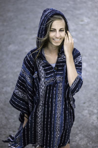 High angle view of happy young woman standing on road