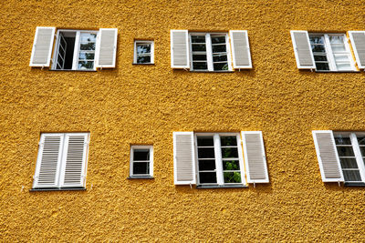 Low angle view of yellow windows on building