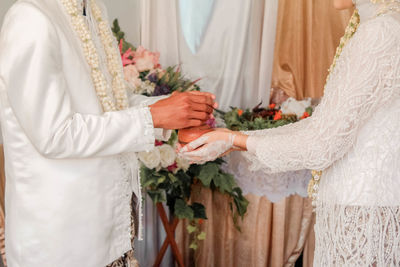 Close-up of flower bouquet against white wall