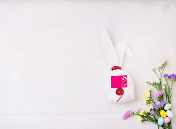 High angle view of pink flower on white table