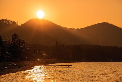 Scenic view of lake against sky during sunset