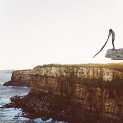 Full length of woman standing on rocks