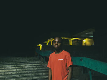 Portrait of young man standing at night