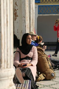 Young couple sitting outdoors