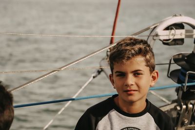 Portrait of boy smiling by sea