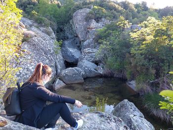 Woman sitting on rock