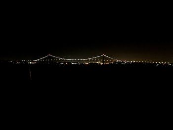 Illuminated suspension bridge at night