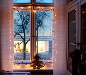 View of christmas tree through window in winter