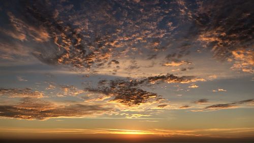 Low angle view of dramatic sky during sunset